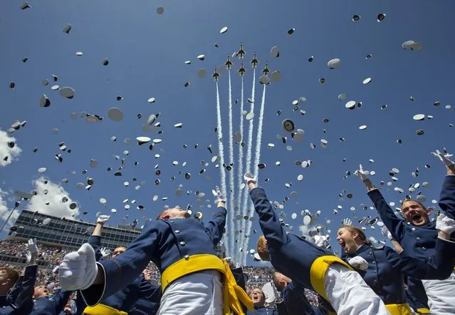 The Air Force Thunderbirds fly overhead as graduating cadets celebrate with the “hat toss” after graduation ceremonies at the 2016 class of the U.S. Air Force Academy, Thursday, June 2, 2016, in Colorado Springs, Colo. (Photo by Pablo Martinez Monsivais/AP Photo)