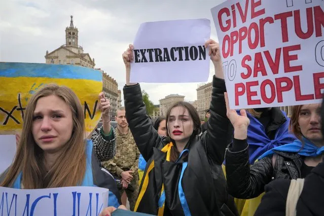 Wives, relatives and activists take part in a rally demanding international leaders to organize a humanitarian corridor for evacuation of Ukrainian military and civilians from Mariupol, amid Russia's invasion of Ukraine, in central Kyiv, Ukraine, Saturday, April 30, 2022. (Photo by Efrem Lukatsky/AP Photo)