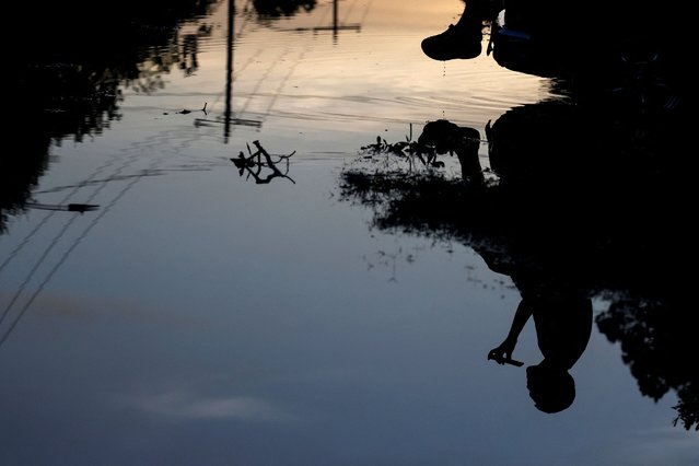 Reflection of a person in floodwaters in the aftermath of Hurricane Beryl, in Houston, Texas on July 8, 2024. (Photo by Daniel Becerril/Reuters)