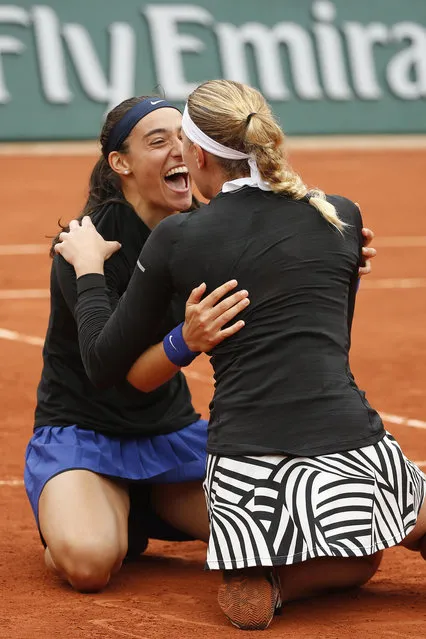 Caroline Garcia, left, and Kristina Mladenovic of France celebrate winning the women's doubles final of the French Open tennis tournament against Ekaterina Makarova and Elena Vesnina of Russia in three sets 6-3, 2-6, 6-4, at the Roland Garros stadium in Paris, France, Sunday, June 5, 2016. (Photo by Alastair Grant/AP Photo)