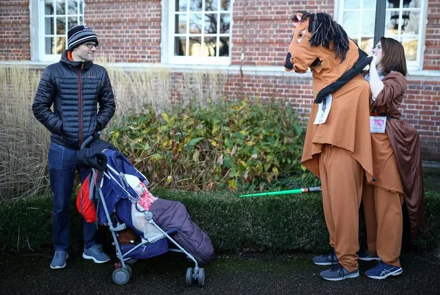 Participants prepare for the annual London Pantomime Horse Race in Greenwich, London on December 15, 2019. (Photo by Tom Nicholson/Reuters)