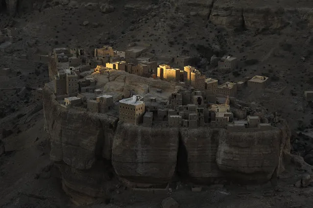 “Sunrise at Wadi Doan”. With my police escort I had arrived at my lodgings at dusk, perched on the edge of a massive escarpment in Yemen's Wadi Doan. In the fading light and on the valley floor I could see this fortresslike village. Having imagined how it might present under a rising sun, I was up at first light. Photo location: Haid Al-Jazil in Wadi Doan, Hadramaut, Yemen. (Photo and caption by Paul Nevin/National Geographic Photo Contest)