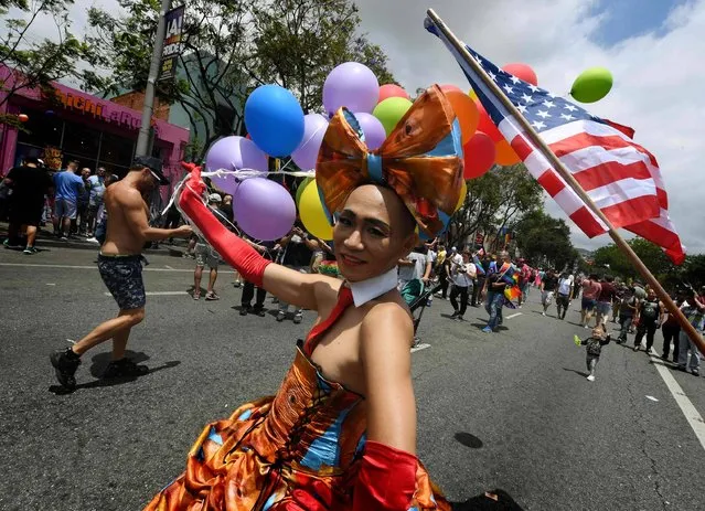 Drag Queen Glamda wears a Donald Trump dress during the the #ResistMarch at the 47th annual LA Pride Festival in West Hollywood, California on June 11, 2017. Inspired by the huge women's marches that took place around the world following the inauguration of President Trump, LA Pride has replaced its decades-old parade with a protest march. (Photo by Mark Ralston/AFP Photo)