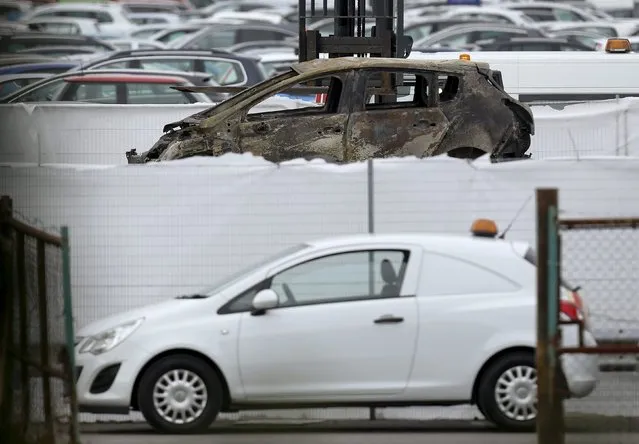 A burned-out car is removed from the site of the airplane crash at the British Car Auctions lot next to Blackbushe Airport, near Camberley in southern Britain August 1, 2015. A private jet crashed in southern England on Friday, killing four people on board, a spokesman for Britain's Hampshire police service said, and Saudi and British media said the passengers were relatives of deceased al Qaeda leader Osama Bin Laden. (Photo by Luke MacGregor/Reuters)