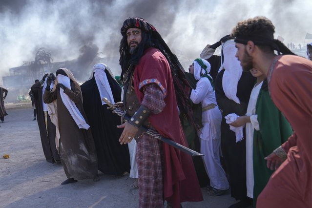 Shiite Muslims re-enact the seventh century battle of Karbala during activities marking the holy day of Ashoura, in the Shiite neighborhood of Sadr City, Baghdad, Iraq, Wednesday, July. 17, 2024. Ashoura is the annual Shiite Muslim commemoration marking the death of Imam Hussein, the grandson of the Prophet Muhammad, at the Battle of Karbala in present-day Iraq, in the 7th century. (Photo by Hadi Mizban/AP Photo)