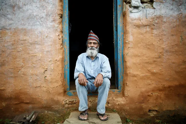 Durga Kami, 68, who is currently studying tenth grade at Shree Kala Bhairab Higher Secondary School, poses for a picture without his school uniform at the door of his one-room house in Syangja, Nepal, June 5, 2016. (Photo by Navesh Chitrakar/Reuters)