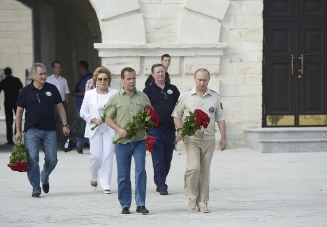 Russian President Vladimir Putin (R), accompanied by Prime Minister Dmitry Medvedev (L, front),  head of the presidential administration Sergei Ivanov (R, back), Federation Council Speaker Valentina Matviyenko (C, back) and Defence Minister Sergei Shoigu, visits the restored historical Konstantinovskaya casemated battery, a fortified cannon position for guarding the bay, in Sevastopol, Crimea, August 18, 2015. (Photo by Alexei Nikolsky/Reuters/RIA Novosti/Kremlin)