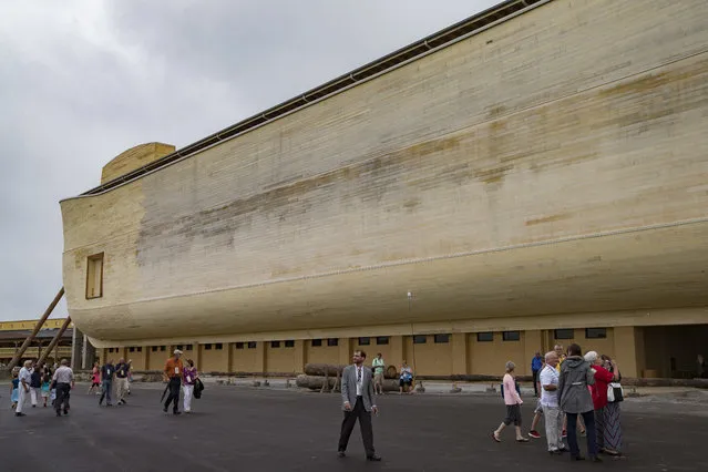 Visitors roam the Ark Encounter theme park as a replica of Noah's Ark stands in the background during a media preview day, Tuesday, July 5, 2016, in Williamstown, Ky. (Photo by John Minchillo/AP Photo)