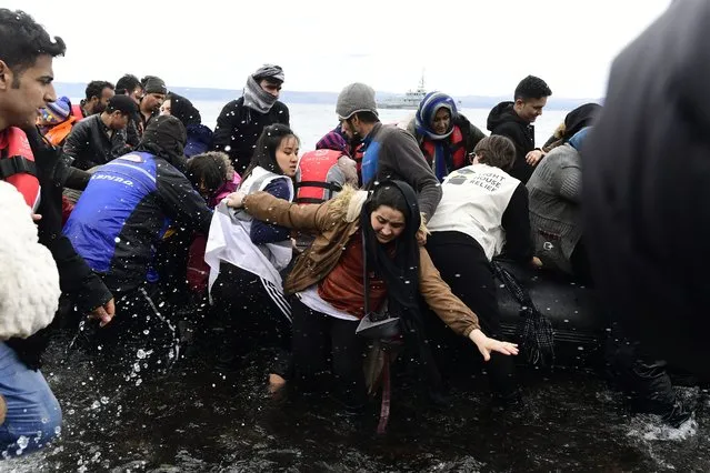 Migrants arrive with a dinghy at the village of Skala Sikaminias, on the Greek island of Lesbos, after crossing the Aegean sea from Turkey, on Friday, February 28, 2020. NATO envoys held emergency talks at the request of Turkey, a NATO member, and scores of migrants began converging on Turkey's border with Greece seeking entry into Europe after Turkey said it was “no longer able to hold refugees”. (Photo by Michael Varaklas/AP Photo)