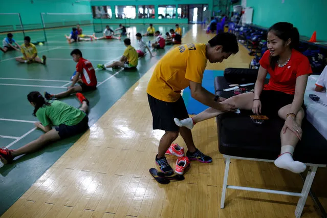 Thailand's badminton player Ratchanok Intanon, who hopes to win gold at the Rio Olympics, receives a massage during an afternoon training session at a gym in Bangkok, Thailand, June 22, 2016. (Photo by Athit Perawongmetha/Reuters)