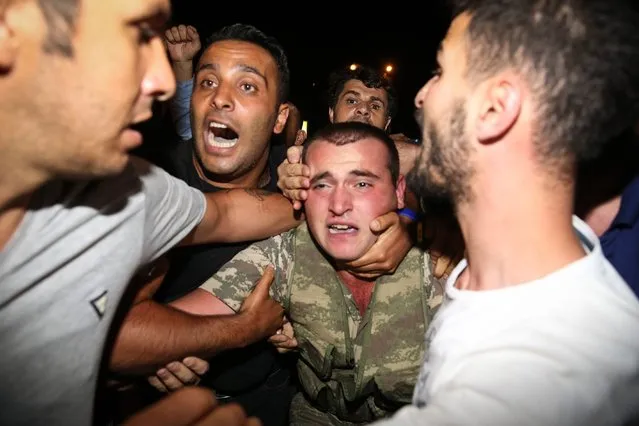 A group of soldiers, attended Parallel State/Gulenist Terrorist Organization's coup attempt, are being neutralized after they tried to storm into state run Turkish Radio and Television Corporation (TRT) in Ankara, Turkey on July 16, 2016 while people are reacting against military coup attempt. Parallel state is an illegal organization backed by U.S.-based preacher Fethullah Gulen. (Photo by Cem Ozdel/Anadolu Agency/Getty Images)