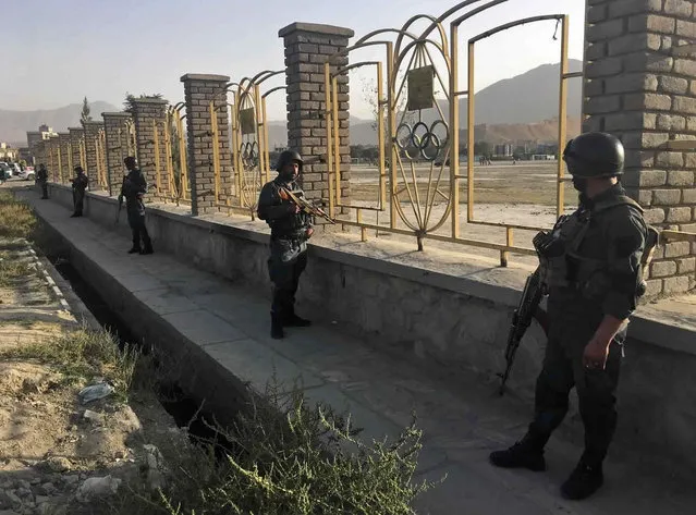 Afghan security police stand guard near the site of a deadly suicide attack outside a cricket stadium, in Kabul, Afghanistan, Wednesday, September 13, 2017. (Photo by Rahmat Gul/AP Photo)