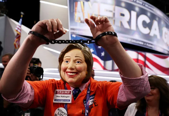 Attendee Wes Nakagiri wears a US Democratic presidential candidate Hillary Clinton mask while walking the floor prior to the start on the fourth day of the Republican National Convention on July 21, 2016 at the Quicken Loans Arena in Cleveland, Ohio. (Photo by Joe Raedle/Getty Images)