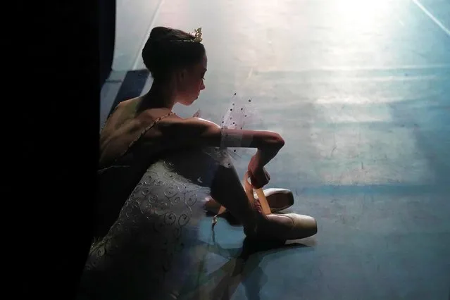 A participant of the XIV International Ballet Competition gets ready backstage before performing at the New Stage of the Bolshoi Theater in Moscow, Russia, Wednesday, June 8, 2022. (Photo by Alexander Zemlianichenko/AP Photo)