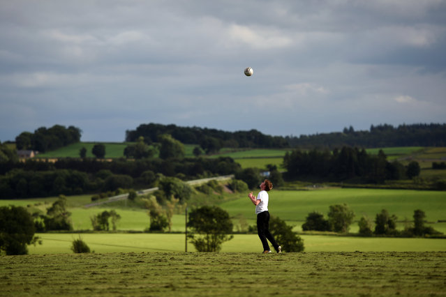 A young boy plays football on the historic battlefield site of Bannockburn on the eve of the battle's anniversary ahead of Thursday's EU Referendum in Scotland, June 22, 2016. (Photo by Clodagh Kilcoyne/Reuters)