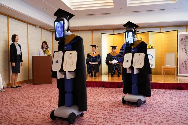iPads attached to “newme” robots stand in for graduating students at a ceremony in graduation gowns and hats in Tokyo, Japan on March 28, 2020. (Photo by BBT University/Handout via Rreuters)