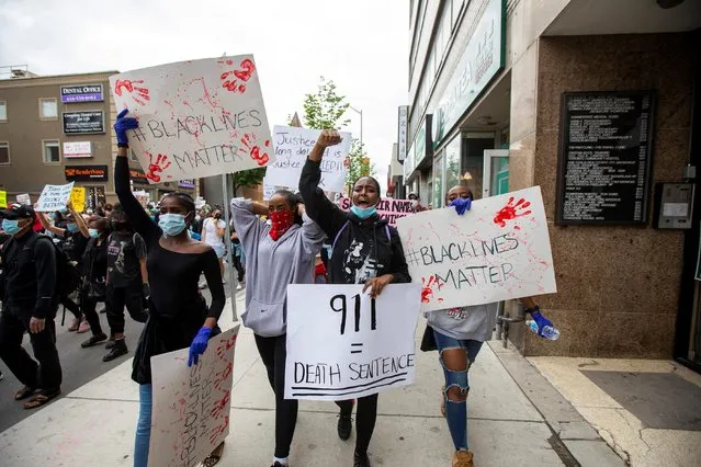 Protesters march to highlight the deaths in the U.S. of Ahmaud Arbery, Breonna Taylor and George Floyd, and of Toronto's Regis Korchinski-Paquet, who died after falling from an apartment building while police officers were present, in Toronto, Ontario, Canada ob May 30, 2020. (Photo by Carlos Osorio/Reuters)