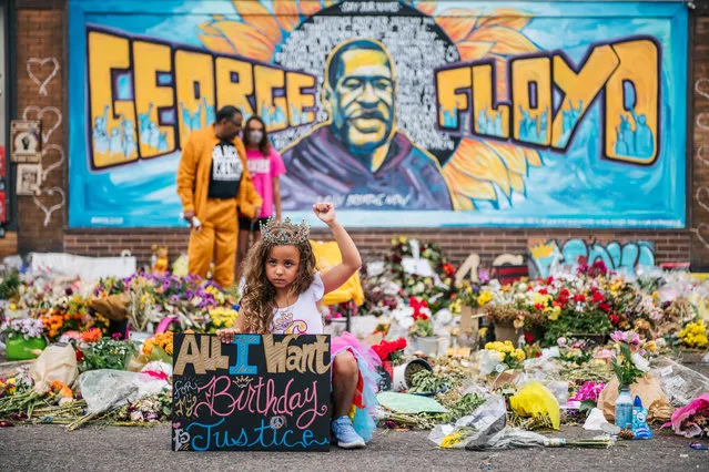 A girl holds her fist in the air while visiting the memorial for George Floyd on June 9, 2020 in Minneapolis, Minnesota. Residents of the community, and people around the world, have come together in calling for an end to police brutality after the death of George Floyd, who was killed while in Minneapolis police custody on May 25th. (Photo by Brandon Bell/Getty Images)