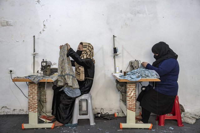 Afghan women work in a sewing workshop in Kabul, Afghanistan, Monday, March 6, 2023. After the Taliban came to power in Afghanistan, women have been deprived of many of their basic rights. (Photo by Ebrahim Noroozi/AP Photo)