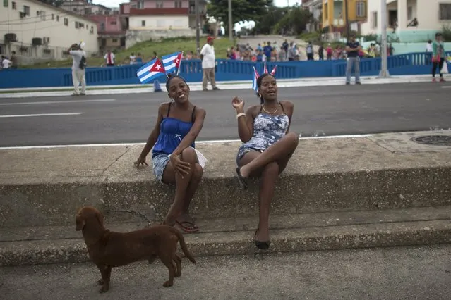 Women react to the camera as they wait for the arrival of Pope Francis from the airport in Havana September 19, 2015. (Photo by Alexandre Meneghini/Reuters)