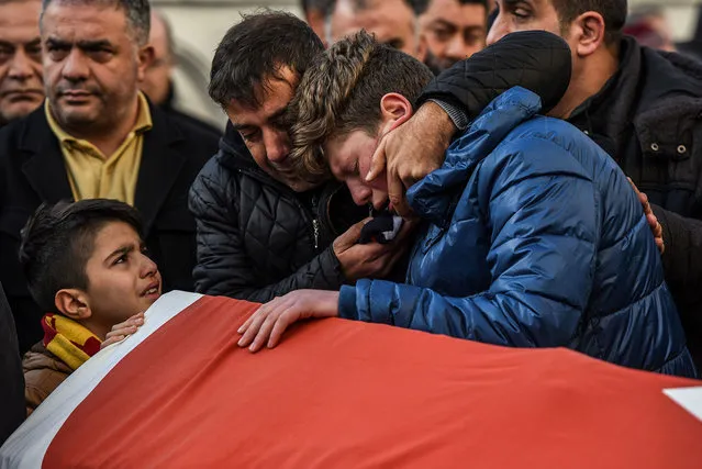 Relatives of Ayhan Arik, one of the victims of the Reina night club attack mourn during his funeral ceremony in Istanbul. Thirty-nine people, including many foreigners, were killed early on January 1, 2017 when a gunman went on a rampage at an exclusive nightclub in Istanbul where revellers were celebrating the New Year. (Photo by Ozan Kose/AFP Photo)