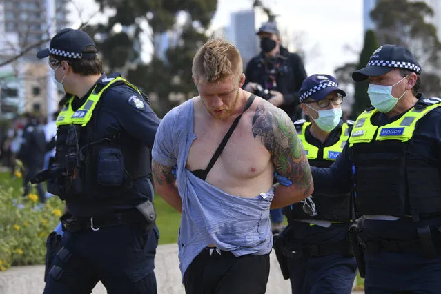 Police arrest a man as people gather at a so-called “Freedom Day” protest in Melbourne, Saturday, September 5, 2020. Police in Australia's hardest-hit Victoria state are urging people to stay away from rallies protesting the lockdown in Melbourne. (Photo by James Ross/AAP Image via AP Photo)