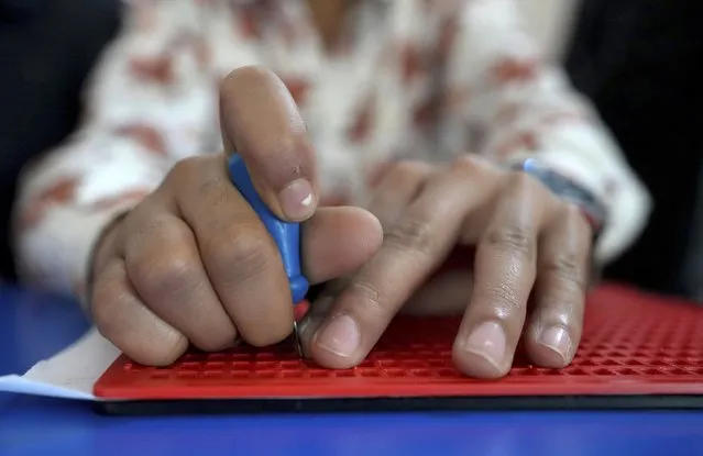 A student with visual disability writes in braille at a government-run school in Hyderabad, India, Tuesday, January 3, 2023. (Photo by Mahesh Kumar A./AP Photo)