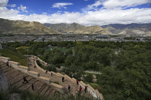 Tourists on the steps of the Potala Palace overlooking Lhasa city in Tibet Autonomous Region, China, 11 September 2016. (Photo by How Hwee Young/EPA)