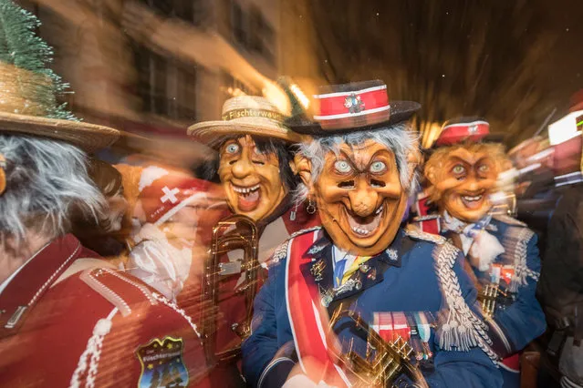 A carnival music group walks through the streets of Lucerne during the Urknall, which marks the start of the Lucerne Carnival on Dirty Thursday in Lucerne, Switzerland, 07 February 2018. (Photo by Urs Flueeler/EPA/EFE)