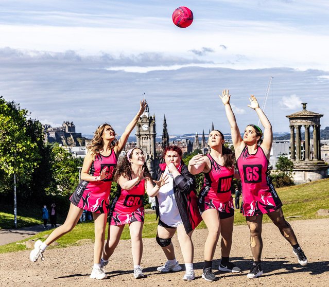 Performers from Crash Theatre Co dressed in pink netball vests on Edinburgh's Calton Hill on July 28, 2025. The House of Oz production, Lady Macbeth Played Wing Defence will open at the Edinburgh Fringe Festival from  30 July until 25 August. (Photo by Rich Dyson/Alamy Live News)