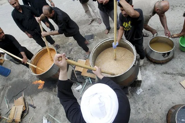 Iraqi men cook Hreesi, a traditional food cooked prior to the 10th day of Ashura in Nabatieh town, southern Lebanon October 23, 2015. Ashura, the most important day in the Shi'ite calendar, commemorates the death of Imam Hussein, grandson of the Prophet Mohammad, in the 7th century battle of Kerbala. (Photo by Ali Hashisho/Reuters)