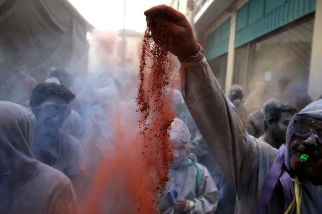 A reveller throws colored flour in Galaxidi, Greece February 19, 2018. (Photo by Alkis Konstantinidis/Reuters)