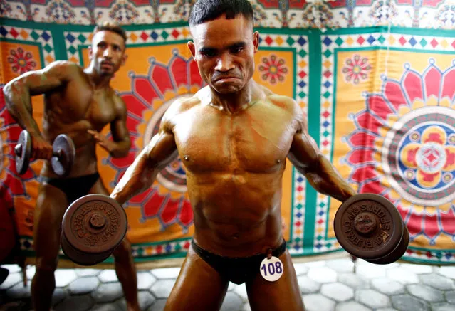 Participants exercise as they get ready for the prejudging round of Dharmashree nationwide bodybuilding championship in Kathmandu, Nepal September 29, 2016. (Photo by Navesh Chitrakar/Reuters)