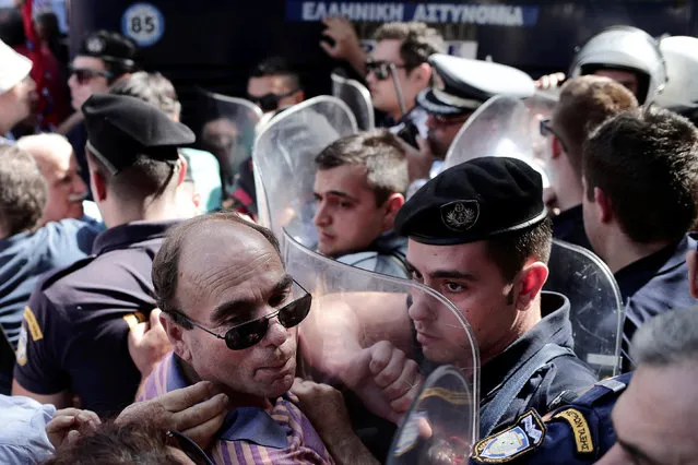 Greek pensioners scuffle with riot police during a demonstration against planned pension cuts, in Athens, Greece, October 3, 2016. (Photo by Alkis Konstantinidis/Reuters)