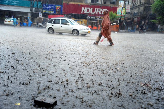Vehicles drive amid rainfall in Hyderabad, Pakistan, 27 June 2025. Heavy monsoon rains have impacted major cities across Pakistan, including Islamabad, Lahore, Hyderabad and Karachi, triggering urban flooding and power outages. Authorities remain on high alert. (Photo by Nadeem Khawar/EPA)
