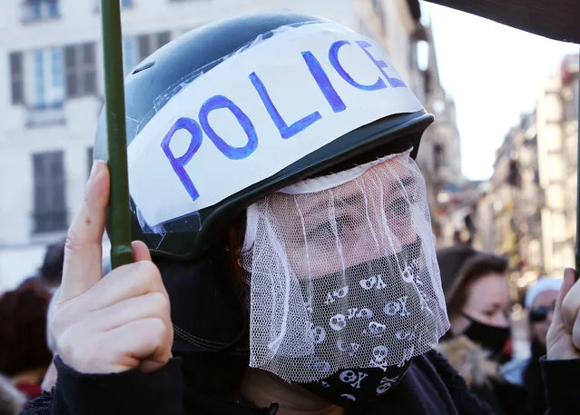A protestor gestures, in Bayonne, southwestern France, Saturday, November 21, 2020. Rights campaigners and journalists organizations staged street protests in Paris and other French cities against a security bill that they say would be a violation of the freedom of information. The proposed measure would create a new criminal offense of publishing images of police officers with intent to cause them harm. (Photo by Bob Edme/AP Photo)