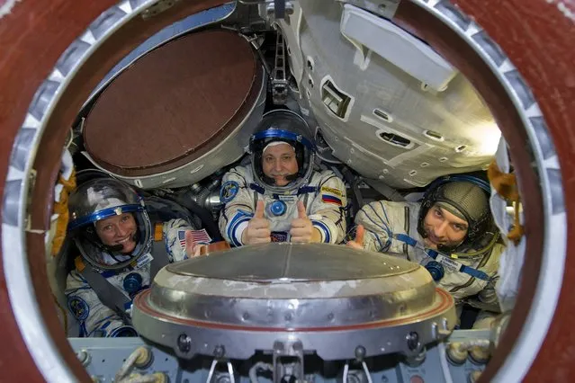 European Space Agency astronaut Luca Parmitano (R), NASA astronaut Karen Nyberg (L) and Russian cosmonaut Fyodor Yurchikhin pose for a picture before taking part in a simulation exercise at the Star City cosmonaut training centre outside Moscow April 26, 2013. The three person team is scheduled to launch for the International Space Station in May. (Photo by Sergei Remezov/Reuters)