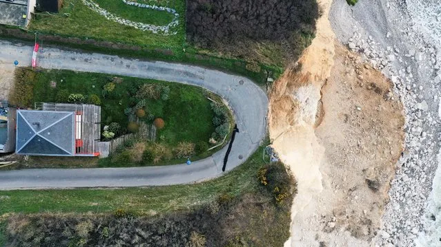 A view shows a road and house near a part of Cap Fagnet cliff that crashed into the sea in February due to coastal erosion, in Fecamp, France on March 02, 2023. (Photo by Pascal Rossignol/Reuters)