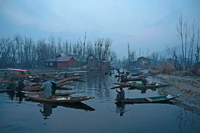 Vendors display their wares in an early morning floating vegetable-market at the interiors of Dal Lake, in Srinagar on December 21, 2020. (Photo by Tauseef Mustafa/AFP Photo)
