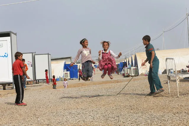 Displaced children who fled Islamic State militants from Mosul play at Debaga camp, on the outskirts of Erbil, Iraq on October 28, 2016. (Photo by Alaa Al-Marjani/Reuters)