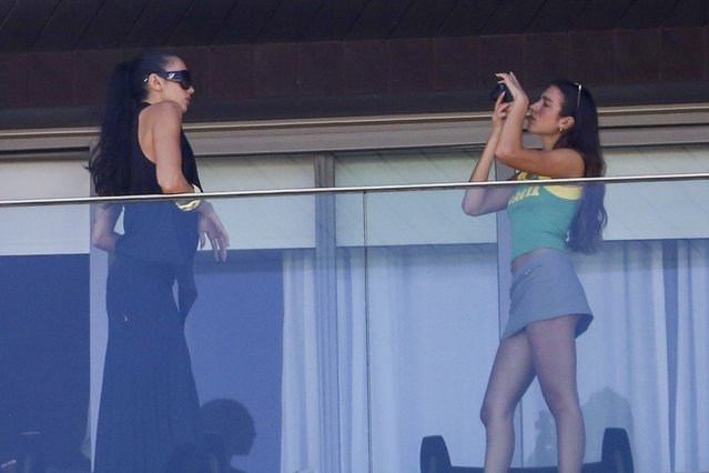 Dua Lipa was seen enjoying a fun moment with her sister, Rina Lipa, as they took photographs of each other on the balcony of Hotel Fasano in Ipanema in Rio de Janeiro on November 21, 2025. The pop star looked relaxed and carefree while capturing the stunning views of the iconic neighborhood, soaking in the vibrant atmosphere ahead of her performance at Farmasi Arena in Rio de Janeiro. (Photo by JUCE/BACKGRID)