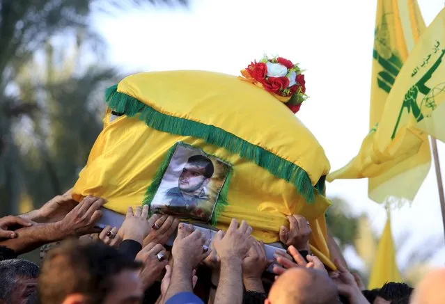 Relatives and Lebanon's Hezbollah members carry the coffin of their comrade, Ali Tnana, who was killed fighting alongside Syrian army forces in Syria, during his funeral in Saksakieh village, southern Lebanon, November 27, 2015. (Photo by Ali Hashisho/Reuters)
