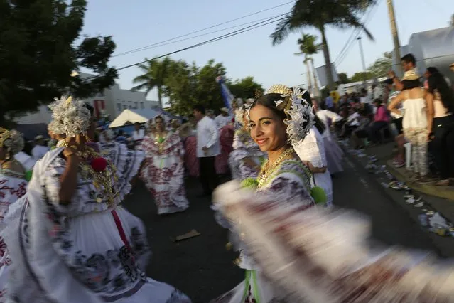 A woman wearing traditional clothing known as “Pollera” dances as she takes part in the annual Thousand Polleras parade in Las Tablas, in the province of Los Santos January 10, 2015. (Photo by Carlos Jasso/Reuters)
