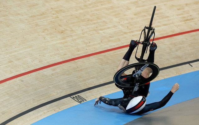 Britain's Hamish Turnbull suffers a crash in a men's track cycling keirin semi-final of the Paris 2024 Olympic Games at the Saint-Quentin-en-Yvelines National Velodrome in Montigny-le-Bretonneux, south-west of Paris, on August 11, 2024. (Photo by Matthew Childs/Reuters)