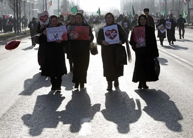 Women attend a rally to protest against satirical cartoons of prophet Mohammad, in Grozny, Chechnya January 19, 2015. The Arabic characters on the posters read, “Mohammad”. (Photo by Eduard Korniyenko/Reuters)