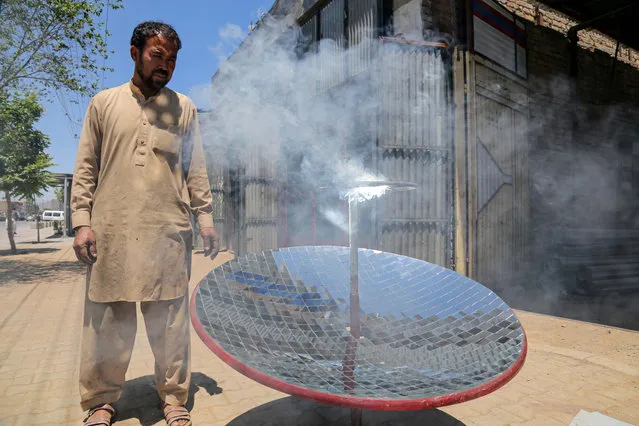 Ghulam Abbas, a local blacksmith tests a Solar Cooker he manufactures at his workshop in Kabul, Afghanistan, 08 May 2023. Ghulam Abbas has been making solar water heaters from basic equipment which can be used to cook food and heat water in a short time for free. He has received orders from the province, and has asked for more attention and support from the Islamic Emirate and businesses to help promote the use of solar energy in the country. Solar cooking has grown in popularity in Afghanistan, due to its convenience and cost-effectiveness. Solar cooking can help reduce the burden of collecting fuel, which is often a difficult task in Afghanistan. (Photo by Samiullah Popal/EPA/EFE)