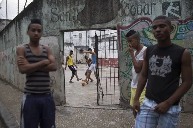 Teenagers play football in an open air sports center in downtown Havana, January 20, 2015. (Photo by Alexandre Meneghini/Reuters)
