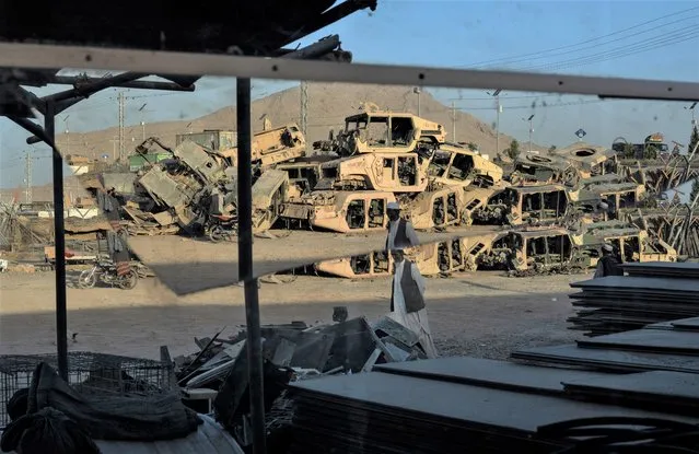 Destroyed Humvess used by the U.S. Army during the war against the Taliban in Afghanistan are seen stacked to be sold as scrap metal in Kandahar City, Afghanistan, Monday, June 12, 2023. (Photo by Rodrigo Abd/AP Photo)