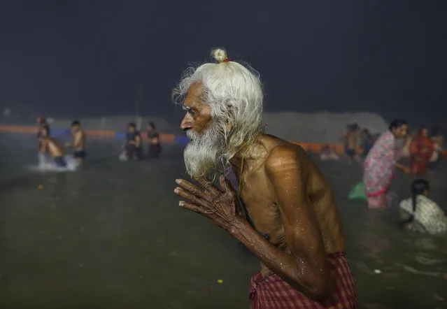 An elderly pilgrim prays after a holy dip at the Sangam in Prayagraj, India, Thursday, February 11, 2021. When the coronavirus pandemic took hold in India, there were fears it would sink the fragile health system of the world’s second-most populous country. Infections climbed dramatically for months and at one point India looked like it might overtake the United States as the country with the highest case toll. But infections began to plummet in September, and experts aren’t sure why. (Photo by Rajesh Kumar Singh/AP Photo)