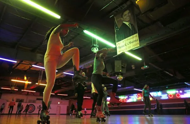 Roller skaters dance to the music under a banner of U.S. President Barack Obama at “The Rink” during an evening session in Chicago, Illinois, January 15, 2015. A handful of decades-old skating venues put Chicago at the center of a vibrant African-American subculture of urban roller skate dancing that stretches from Atlanta to Detroit and from Los Angeles to New York. (Photo by Jim Young/Reuters)